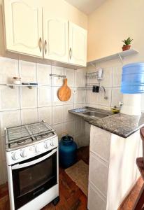 a kitchen with a stove and a sink at Melhor Localização do Centro Histórico de Salvador in Salvador