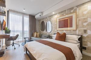 a bedroom with a large bed and a living room at 5 Star Elegant Apartments, Ellipse, Waterfall City, Midrand, Johannesburg in Midrand