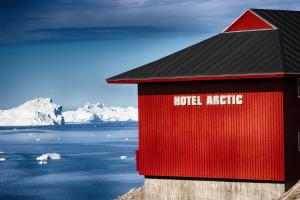 a red building with the words hotel attic written on it at Hotel Arctic in Ilulissat