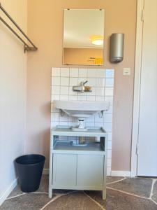a bathroom with a sink and a mirror at B&B Villa Vila in Löttorp +60 photos