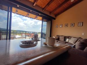 a living room with a table with cups and a couch at Casa Luca in Mazamitla