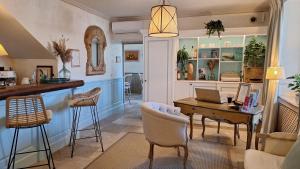 a kitchen with a table with a laptop on it at Hotel Villa Catarie in Guéthary