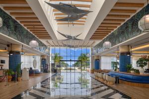 a lobby with a shark hanging from the ceiling at Ocean Eden Bay - Adults Only - All Inclusive in Falmouth