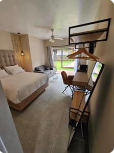 a bedroom with a bed and a desk with a desk at Grey heron in Boksburg
