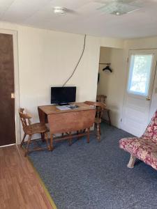 a room with a desk with a computer and a couch at Inn at the Isles in Isle la Motte