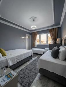 a bedroom with two beds and a large window at Aspawa Hotel in Pamukkale +71 photos