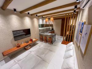 a living room with a couch and a fireplace at Brisa e Sal in São Miguel dos Milagres