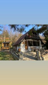 a small white building with a black roof at Vila Krnjević Jastrebac in Buci