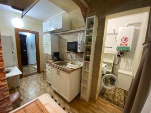 a small kitchen with a sink and a microwave at Lemora Apartments 3 in Focşani