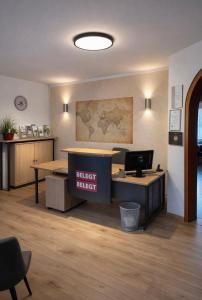 an office with a desk with a sign that readsbid basket at Pension Genz in Bad Karlshafen