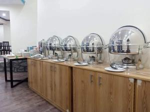 a row of wooden cabinets with mirrors on top of them at Ameer lodge in Hunza Valley