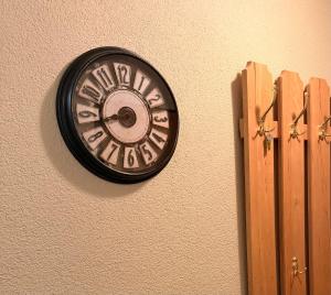 a clock is hanging on a wall at daroomz in Gloggnitz
