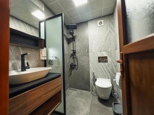 a bathroom with a sink and a toilet at Doga Motel in Uzungöl +79 photos