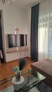 a living room with a large flat screen tv on the wall at Apartments Kimm II in Poreč