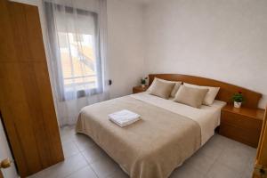 a bedroom with a bed with a towel on it at Blue House Calafell in Calafell +8 photos