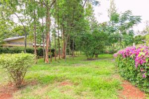 a garden with flowers in front of a building at Asili House in Sagana +12 photos