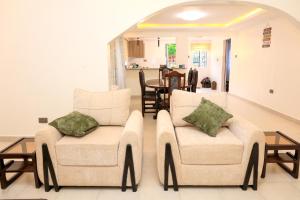 a living room with two chairs and a table at Asili House in Sagana