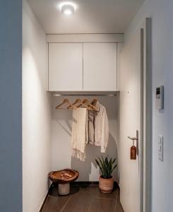 a room with a closet with white cabinets at Central and well connected modern studio in Zurich