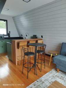 a kitchen with a table and chairs in a room at Dunas beach club in Jaguaruna
