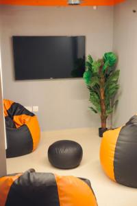 a living room with two bean bags and a flat screen tv at Aostel in Chennai