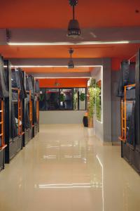 a hallway of a clothing store with an empty floor at Aostel in Chennai +3 photos