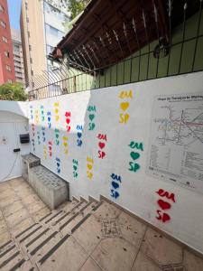 a wall with colorful graffiti on it in a building at Av Paulista GF in São Paulo