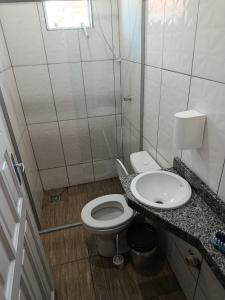 a small bathroom with a toilet and a sink at Pousada Paraiso in Telêmaco Borba
