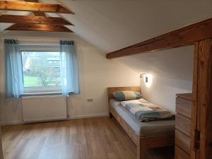 a bedroom with a bed and a window at Gästezimmer Kalletal in Kalletal