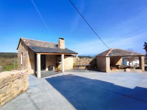 a stone house with a patio and a pavilion at Casa do Cabo in Morás