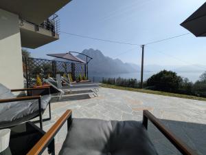 a house with a balcony with a view of the mountains at Dal Ross 2 in Riva di Solto +24 photos