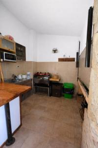 a kitchen with a counter and a stove in it at Los robles in San Pedro