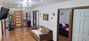 a living room with a couch and a bedroom at Casa Azul in Coñaripe