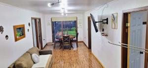 a living room with a couch and a table at Casa Azul in Coñaripe