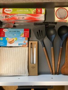 a drawer filled with kitchen utensils on a shelf at Ferienwohnung Strandmuschel in Lembruch