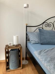 a bedroom with a bed with a lamp and a side table at Ferienwohnung Strandmuschel in Lembruch