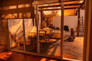 a view of a patio through a glass door at Refúgio do Frade in Aldeia do Mato
