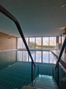 a view of the swimming pool from the stairs of the house at Offline by Alexa in Lahnstein