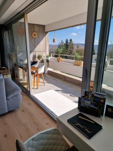 a living room with a large glass window and a table at Offline by Alexa in Lahnstein