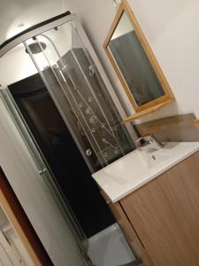 a bathroom with a sink and a mirror at Chambre équipée in Languidic