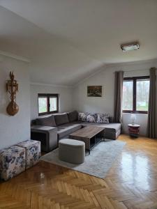 a living room with a couch and a table at Visitor Yard in Plav