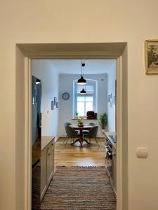 a kitchen and dining room with a table and a dining room at Apartament Pod Tężnią in Głuchołazy