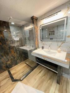 a bathroom with a sink and a mirror at ANATOLI Waterfalls Retreat in Edessa +34 photos