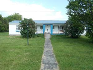 a house with a pathway in front of it at Inn at the Isles in Isle la Motte