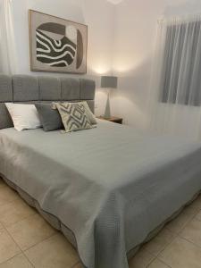 a bedroom with a large bed with a gray headboard at Alkiviades Villa in Theletra +36 photos