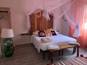 a bedroom with a bed with a canopy at Agriturismo Amarasca in Gagno
