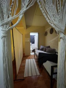 a bedroom with a bed with a canopy at Riddim Vybz guesthouse in Kingston