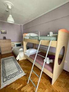 a bedroom with two bunk beds and a rug at ANATOLI Waterfalls Retreat in Edessa