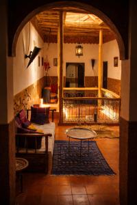 a living room with a couch and a table at Riad Des Vieilles Charrues in Boumalne Dades