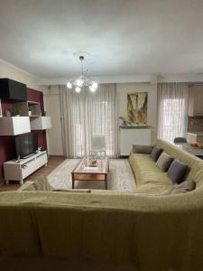 a living room with a couch and a table at ANATOLI Waterfalls Retreat in Edessa