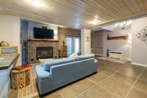 a living room with a blue couch and a fireplace at Lodge At Tellico in Tellico Plains